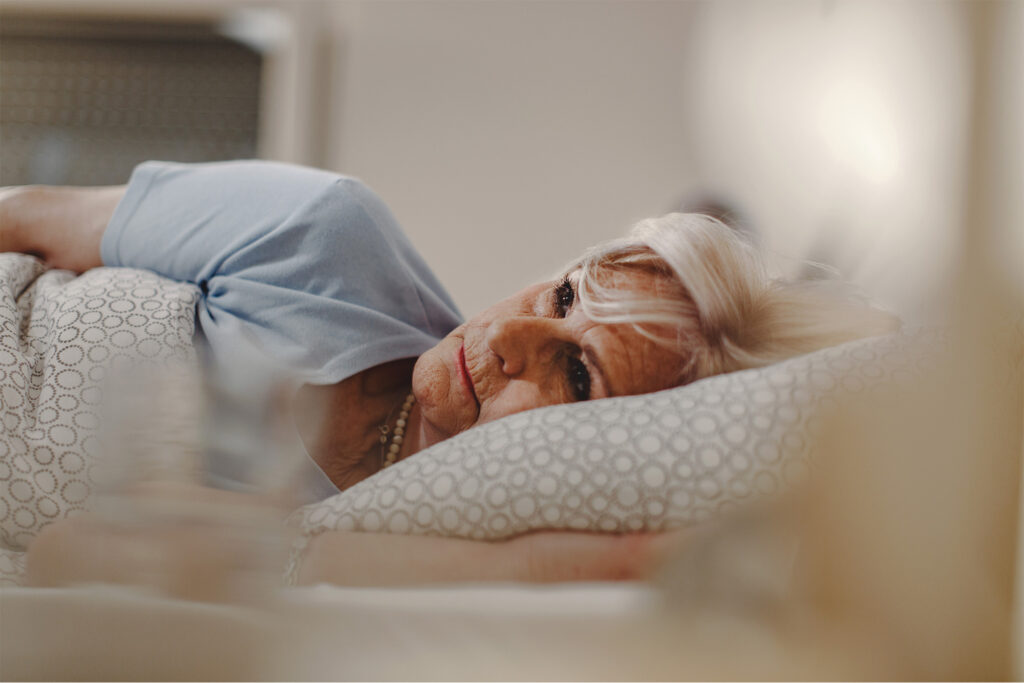 Carer providing gentle nighttime support for elderly client in Christchurch