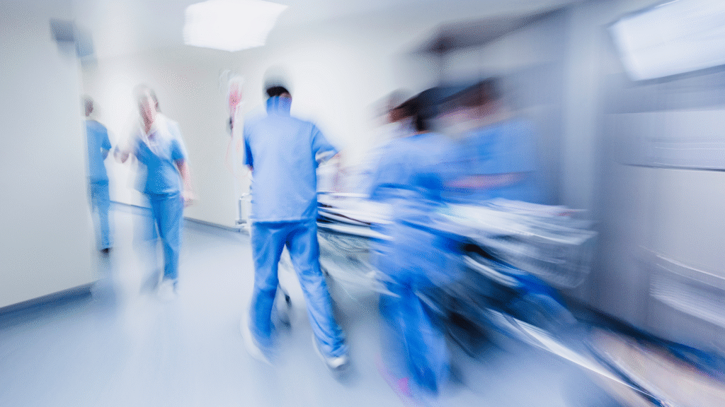 Blurred motion photo of hospital staff responding to an emergency situation, symbolising hospital readmission risk for older people in Christchurch and Tauranga
