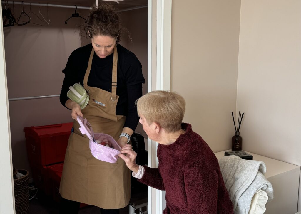 TaskMasters team member helping an older woman organise belongings in Tauranga and Christchurch