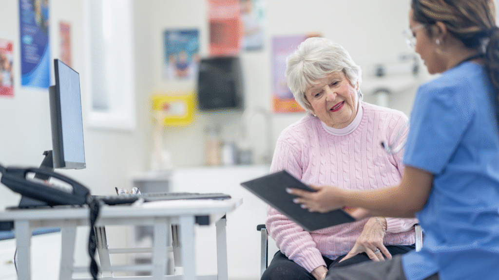 A healthcare professional explaining health information to an older woman during a medical appointment in Christchurch, New Zealand