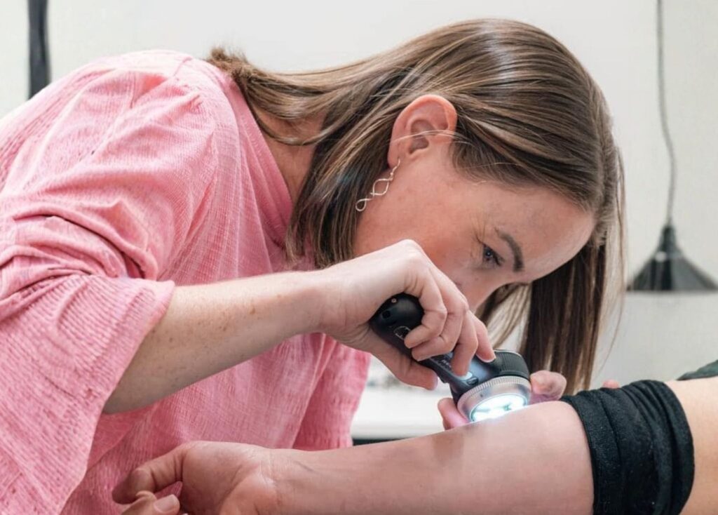 SKiNTUITION Christchurch nurse performing a detailed skin check on a client
